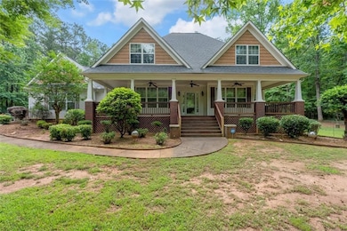 Craftsman inspired home featuring ceiling fan, a porch, a front yard, and roof with shingles