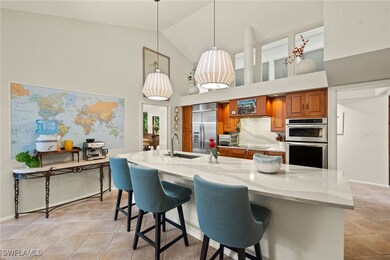 Kitchen with light stone counters, a sink, applian