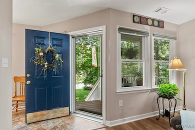 Foyer with plenty of natural light, baseboards, an
