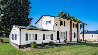 View of front of property with a metal roof and covered porch