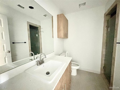 Full bathroom featuring vanity and a shower with door