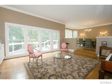 Living Room-with Fireplace and access to the rear deck overlooking the private pool and yard.