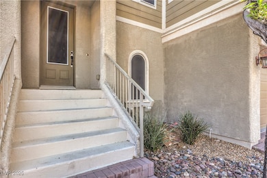 Property entrance featuring stucco siding
