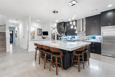 Kitchen featuring built in refrigerator, wall chi