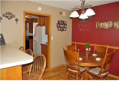 The dining space has the beautiful original hardwo