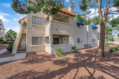 Back of property featuring stucco siding, stairs,