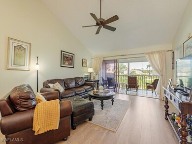 Living room with high vaulted ceiling, light hardw