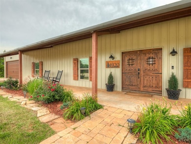 Property entrance with a garage and covered porch