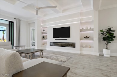 Living area featuring coffered ceiling, ornamental