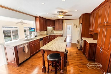 Kitchen with sink, hardwood / wood-style flooring,