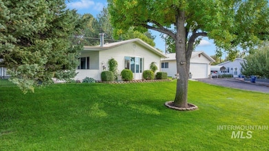 Single story home with a front yard and driveway
