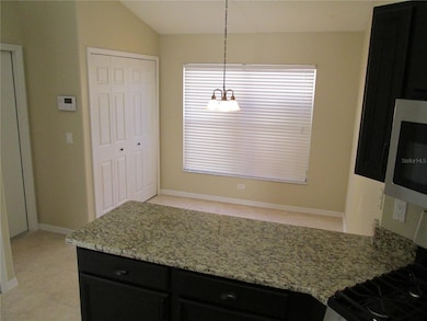 Room for a table, coffee bar or small office in nook just off the kitchen.  Laundry closet in background.  Door leads into garage.
