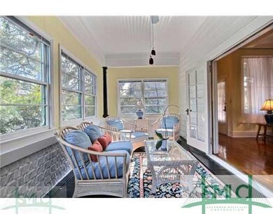 Sunroom. Double French doors lead to a sunny sunro