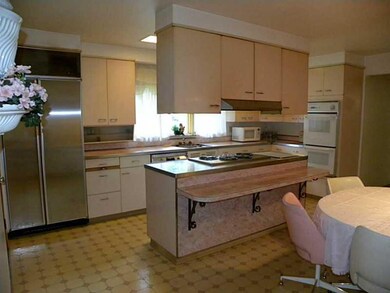 Kitchen. Kitchen has island with gas stove top and