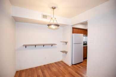 The dining area has a beautiful pendant light.