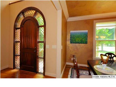 Entry shows off a beautiful door surrounded by lea