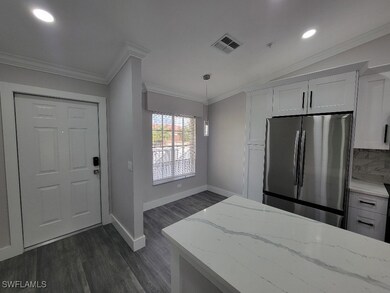 Kitchen featuring white cabinets, crown molding, d