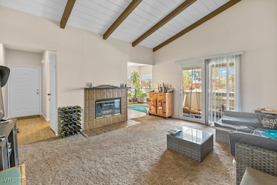 Carpeted living room featuring a fireplace, wood c