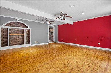 Spare room featuring wood finished floors, beamed 