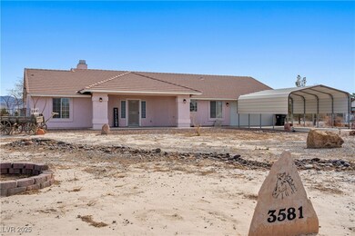 View of front of property with a carport, a chimne