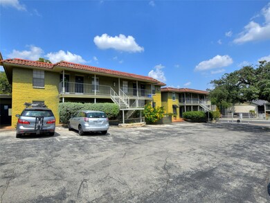 View of building exterior with uncovered parking 