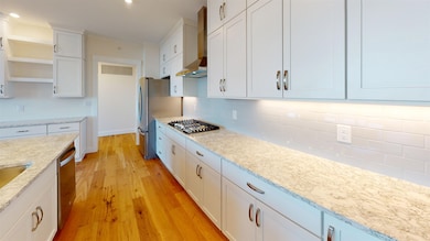 SIMILAR UNIT KITCHEN AREA WITH STOVE AND HOOD