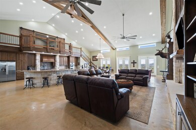 Living area with a ceiling fan, concrete floors, 