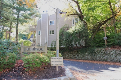The beautifully landscaped entrance to the Fountainwood condominium complex offers a warm and inviting welcome, setting the tone for a peaceful and well-maintained community.