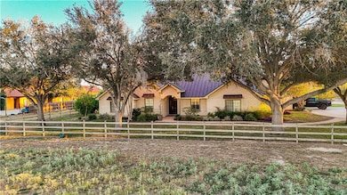 View of front of house featuring a fenced front yard, a metal roof, and a standing seam roof
