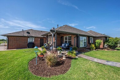 Back of property featuring a yard, brick siding, and an outdoor hangout area
