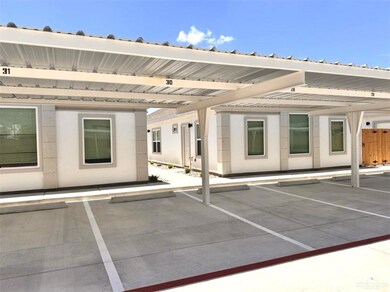 View of exterior entry featuring covered parking