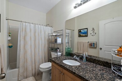 Full bath featuring vanity, shower / bath combo, and light tile patterned floors