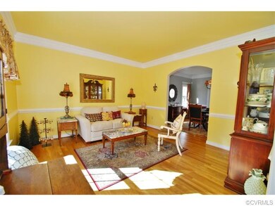 Large living room with hardwood flooring, chair mo