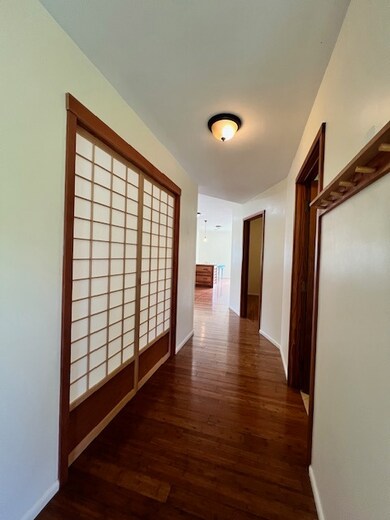 beautiful Shoji doors to the left that enters into the first of two bedrooms in the main home