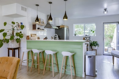 Kitchen featuring light wood-style flooring, wall