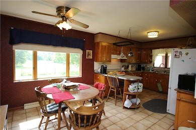 Open 10x10 Dining Room w/ Ceramic Tile Floors, Ceiling Fan Light & Large Window overlooking Private Backyard!