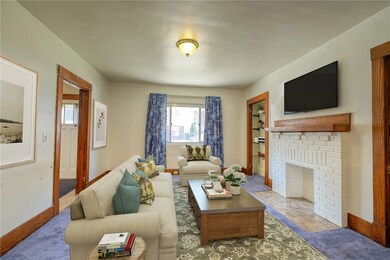 Large living room has hardwood floors under the ca