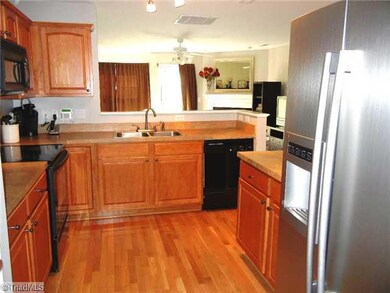 Kitchen. Pretty kitchen with HW flooring, pantry, smooth top stove, built in microwave, dishwasher, and side by side refrigerator remains.