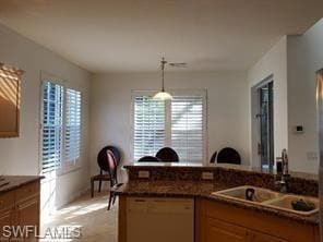 Kitchen with decorative light fixtures, dishwasher