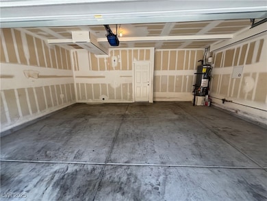Garage featuring strapped water heater