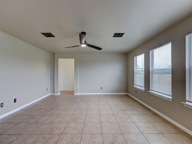 Empty room featuring light tile patterned floorin