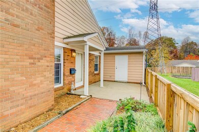 Notice the spacious outdoor storage building! The fenced in front patio also makes a perfect spot for an outdoor barbecue or creating your own private oasis.