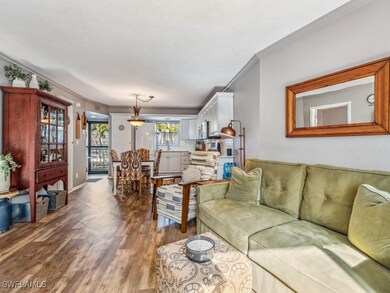 Living room featuring crown molding and wood-style