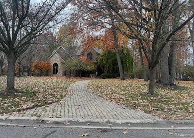 Obstructed view of property featuring stone siding