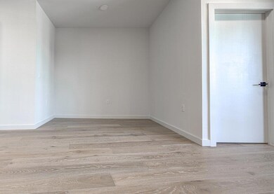 Spare room featuring light wood-type flooring and