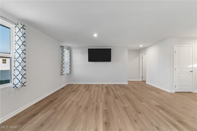 Unfurnished living room featuring recessed lighting and light wood-type flooring