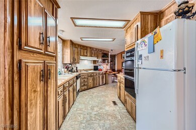 Kitchen with brown cabinetry, a textured ceiling,