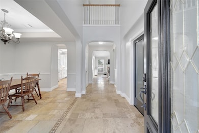 Step inside through the wood and glass front door and appreciate the beautiful travertine tile floors and how light, bright, and open this home fees.