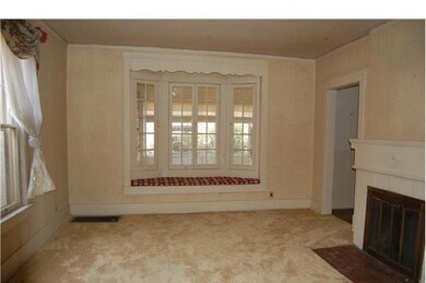 This parlor aoff the entry ccommodates many guests