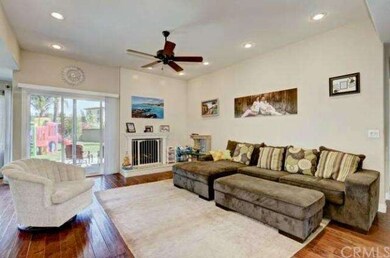 The living room features high ceilings, wood floor